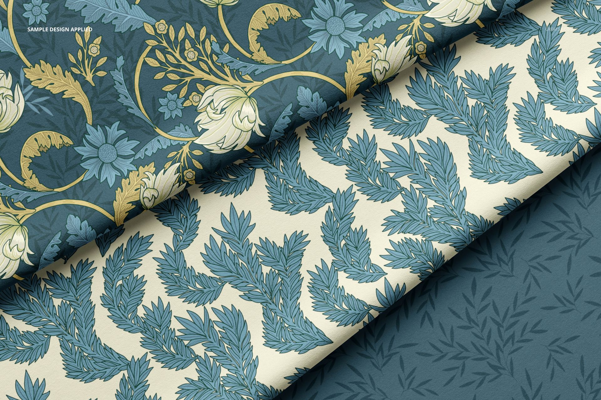 Double brushed polyester fabric mockup with three folded layers, each featuring distinct blue and cream floral and leaf patterns.