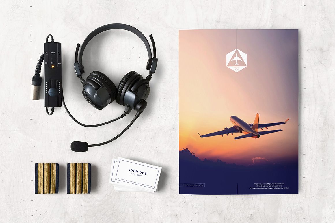 Airlines company mockup set with business cards, headset, and aviation-themed folder on a light surface.