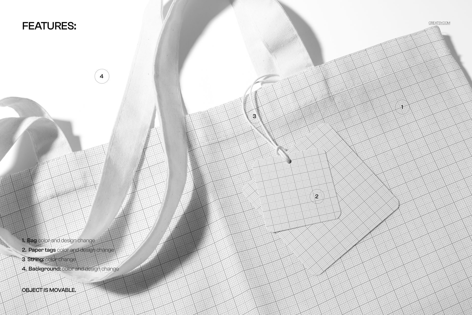 Top view of a white canvas tote bag mockup showing detailed handles and two grid tags on a textured surface.