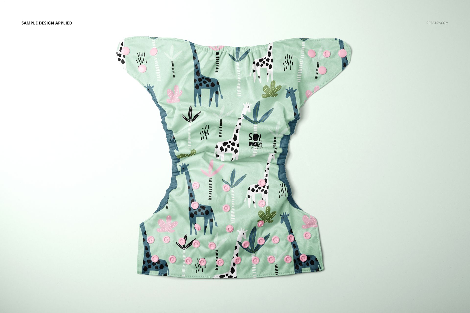 Reusable baby cloth diaper mockup with a pastel green background, featuring giraffe and plant illustrations, top view.