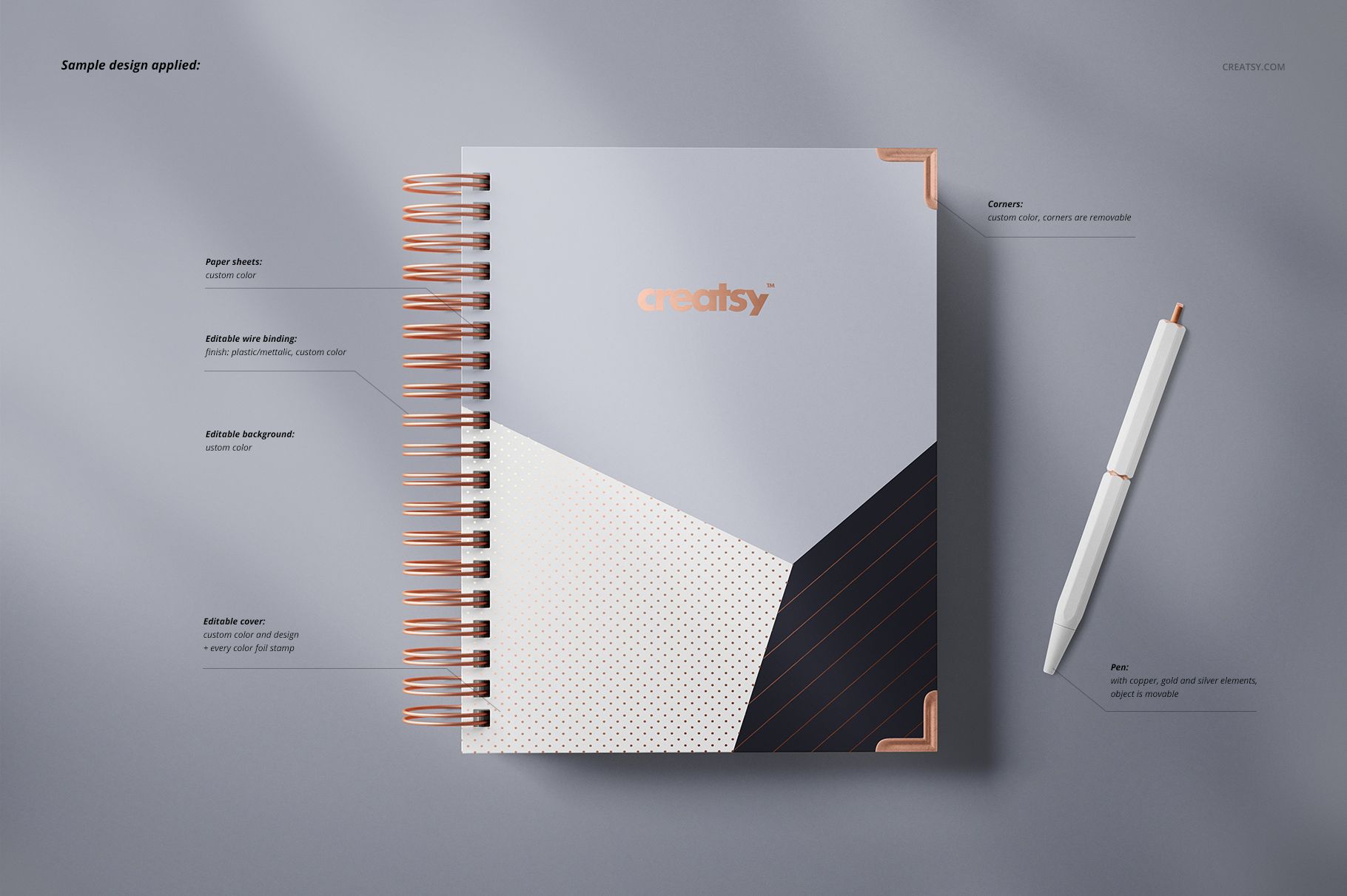 Wire-bound planner mockup with a geometric cover design in white, black, and copper tones, shown from above on a gray surface.