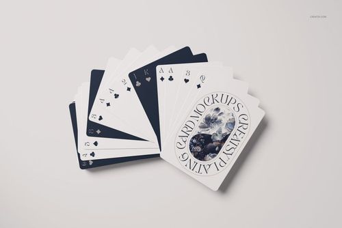 PSD mockup of a playing card deck fanned on a pale background, displaying custom face designs and suit icons.