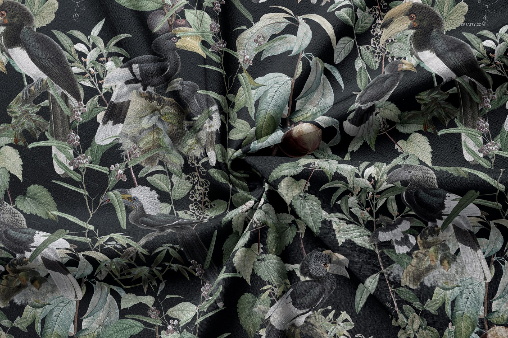 Tablecloth fabric mockup featuring a dark background with a botanical pattern and hornbill birds, shown in a wrinkled top view.