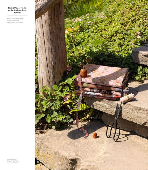 PSD mockup featuring several decorative fabric samples on stone stairs in a garden setting, with sewing accessories visible.