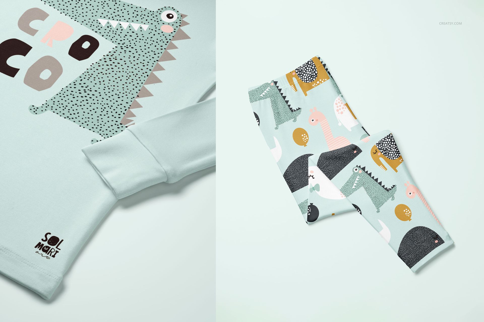 Kids long sleeve pajama mockup set featuring a close-up of a mint green top with crocodile illustration and folded pants with playful animal patterns.