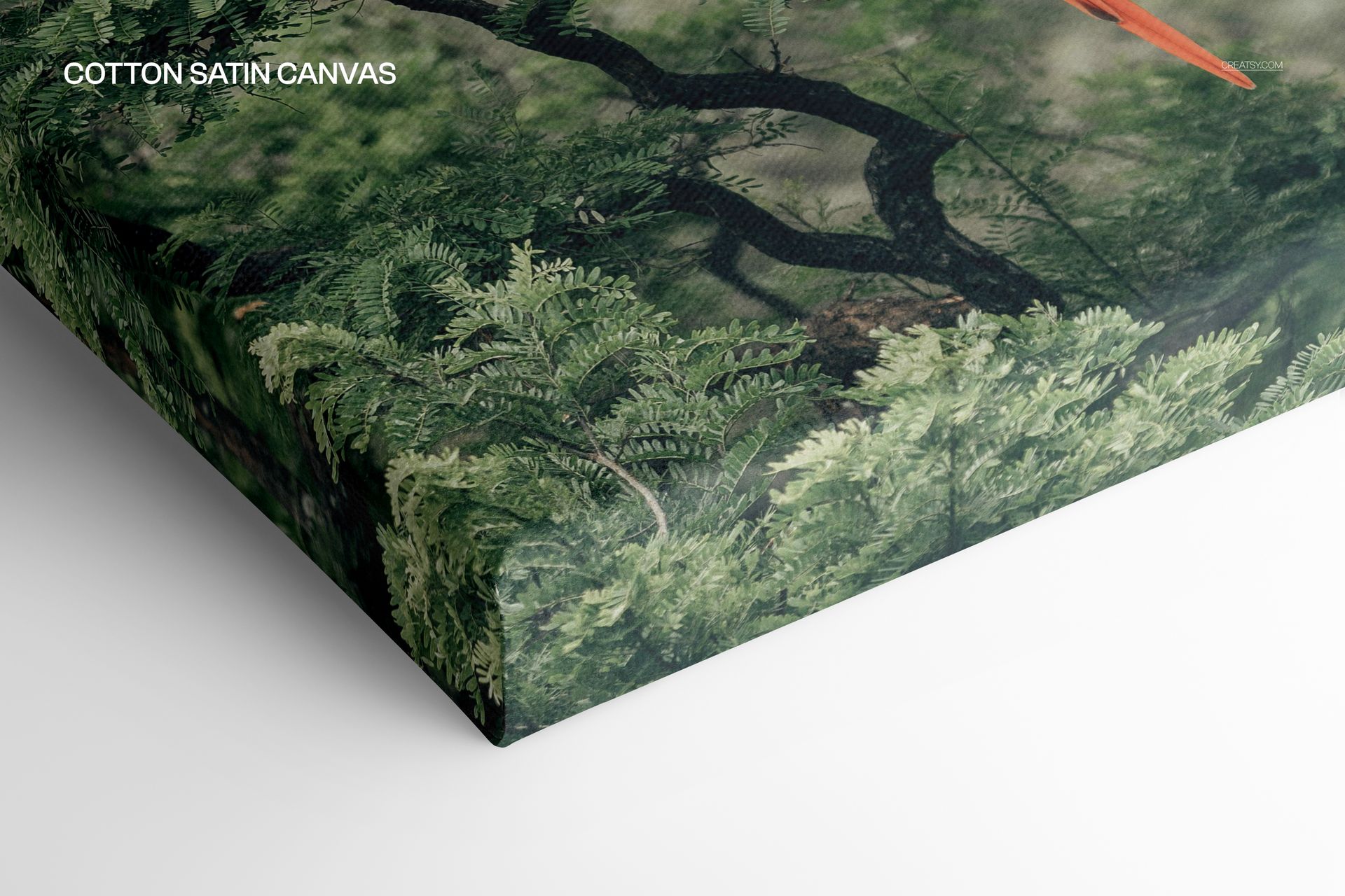 Close-up of a cotton satin canvas print mockup showing detailed green foliage and part of a tree branch.