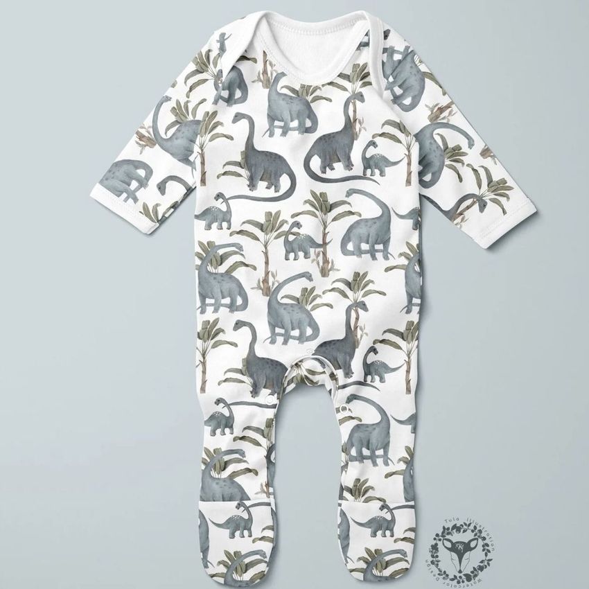 Baby chest rompersuit mockup featuring a repeating diplodocus dinosaur and palm tree pattern on a light background.