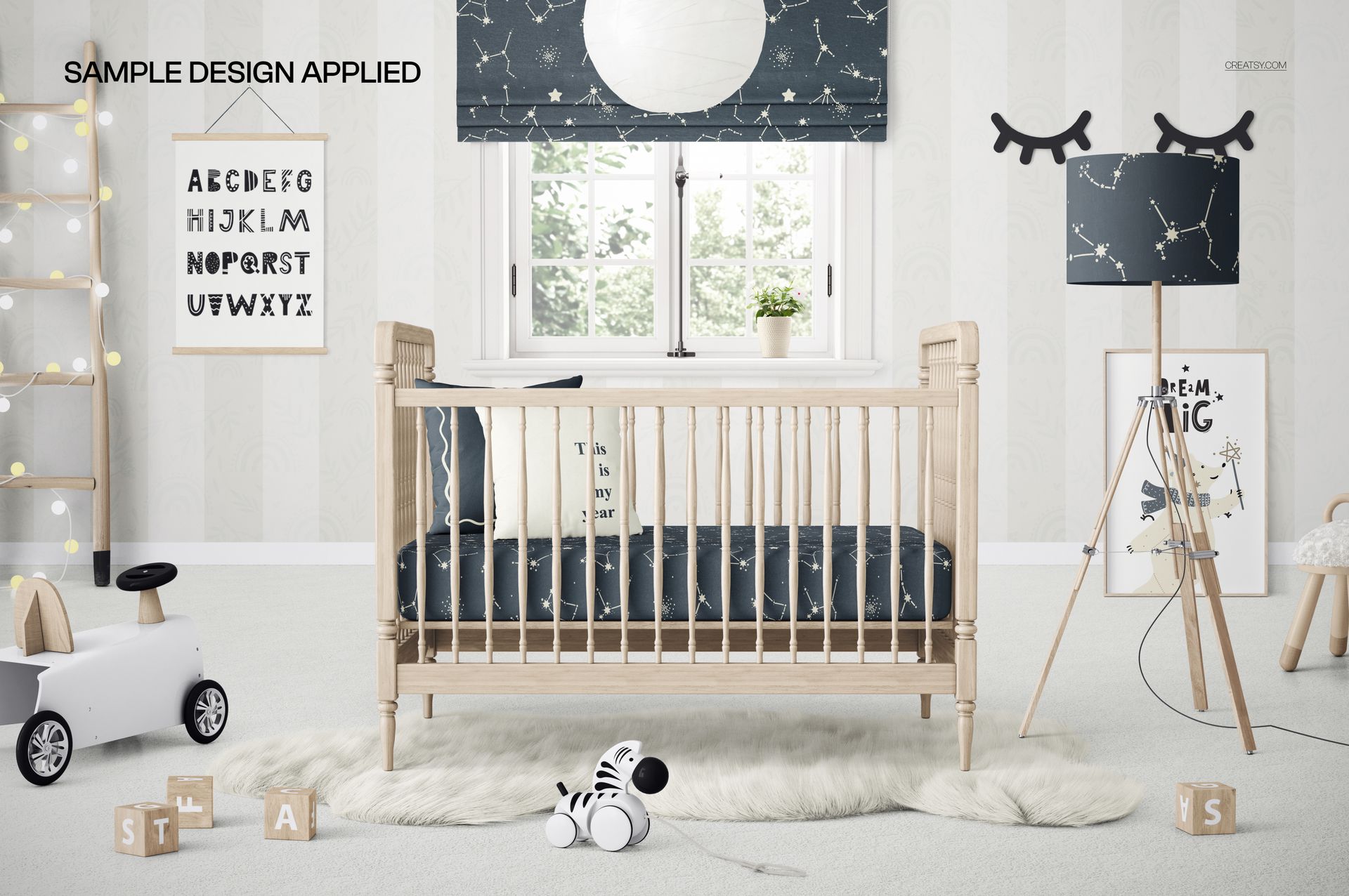 PSD mockup showing a wooden crib with star-themed bedding, alphabet poster, and whimsical nursery accessories.