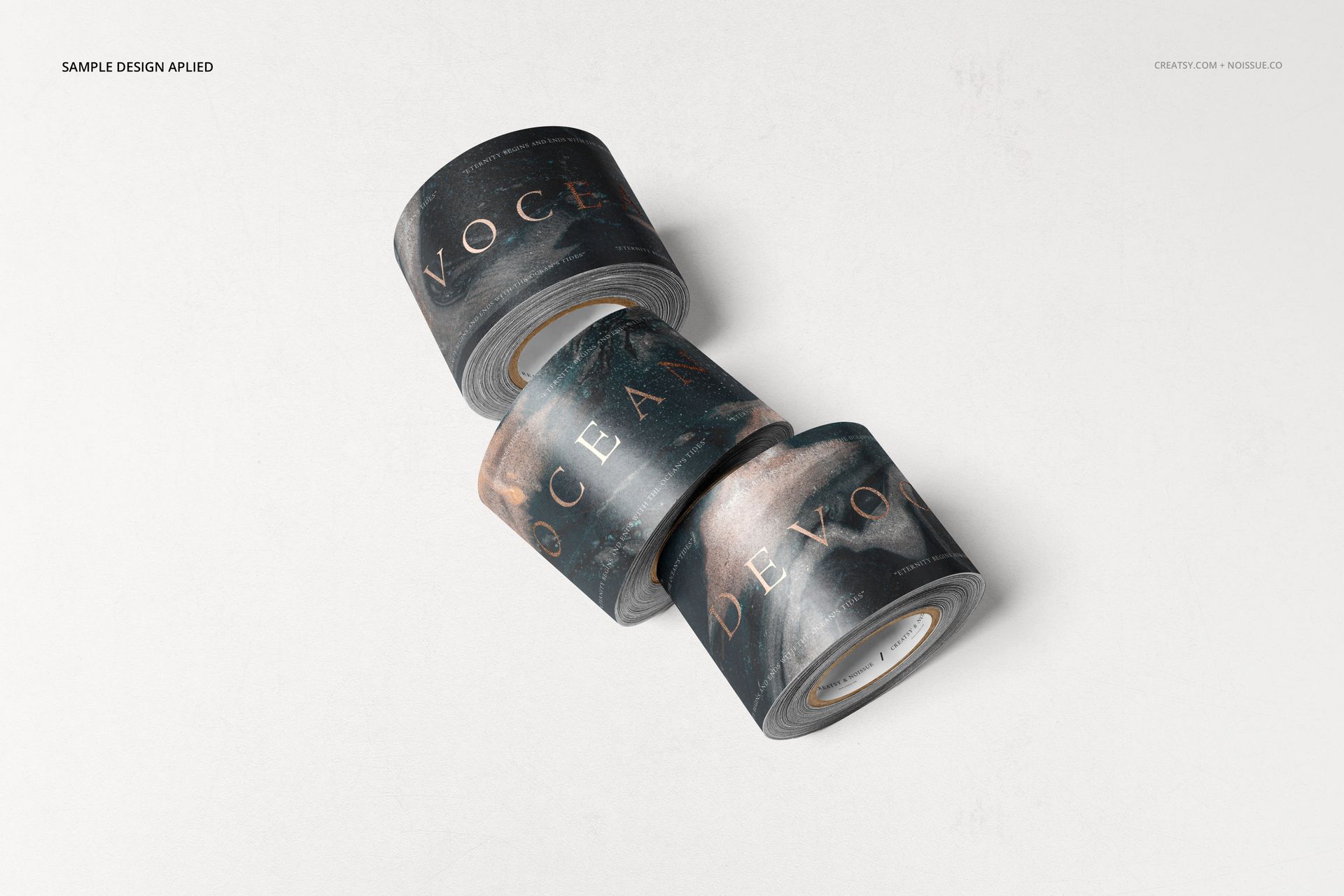 Three rolls of mailing tape with a dark, abstract pattern and gold lettering, arranged on a light surface.