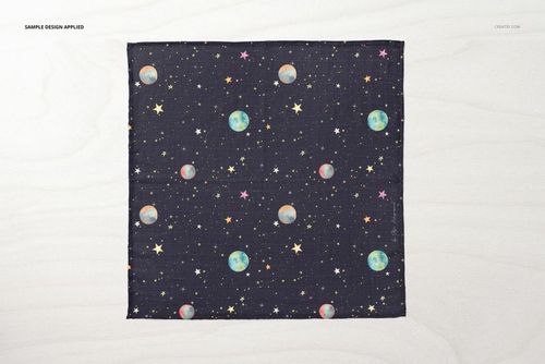 Top-down perspective of a muslin swaddle blanket mockup featuring a celestial pattern with planets and stars.