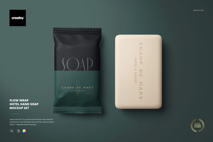 Front view of hotel hand soap mockup with one wrapped soap in dark packaging and one unwrapped beige bar on a green surface.