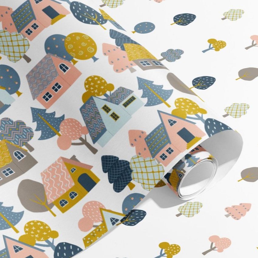 Gift wrapping paper mockup featuring a roll of paper with a colorful hand-drawn house and tree pattern on a white background.