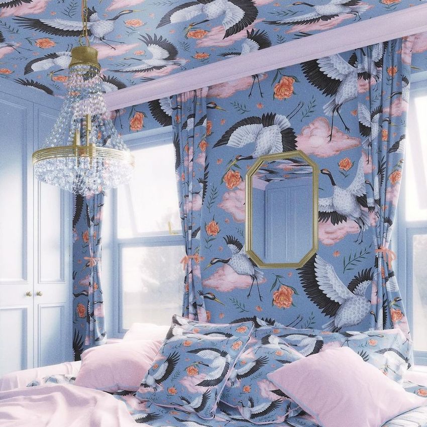 Bedroom mockup with bedding, curtains, and wallpaper featuring a blue crane and floral pattern, pink pillows, and a crystal chandelier.