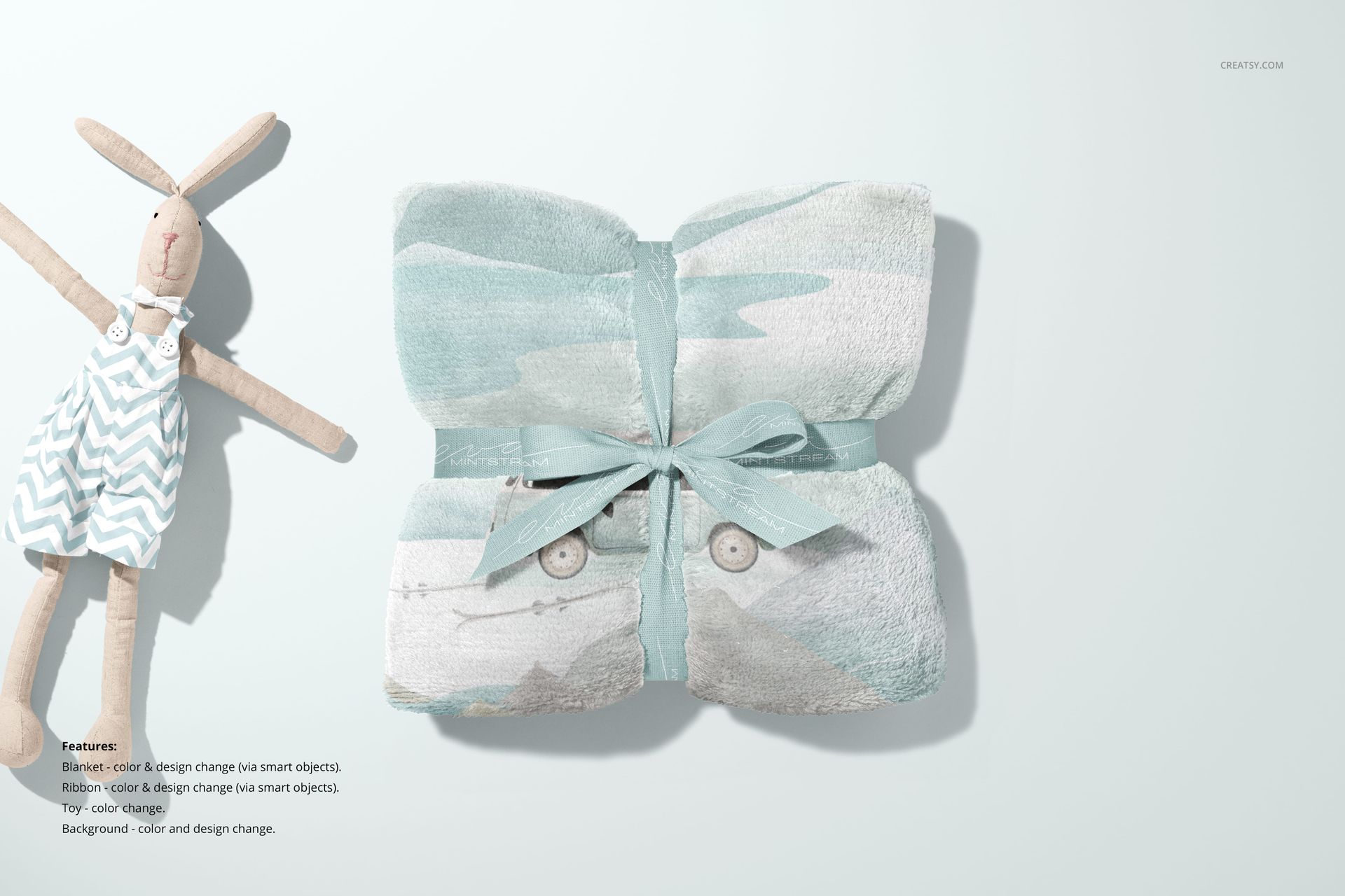 Front view of a 30x40 fleece blanket mockup, ribbon-tied, with light blue and white design beside a plush bunny doll.