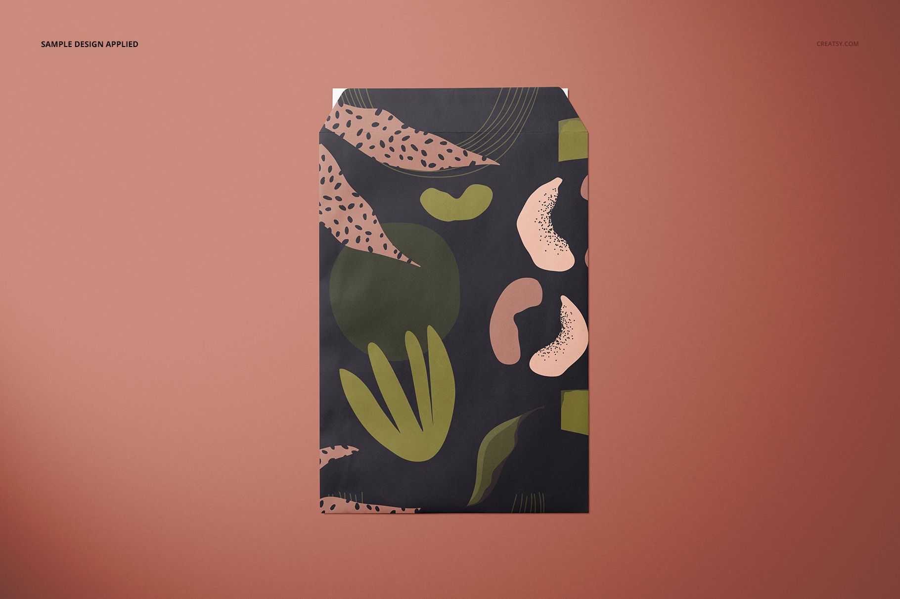 Envelope mockup with organic shapes in green, beige, and pink tones, displayed on a plain brown background.