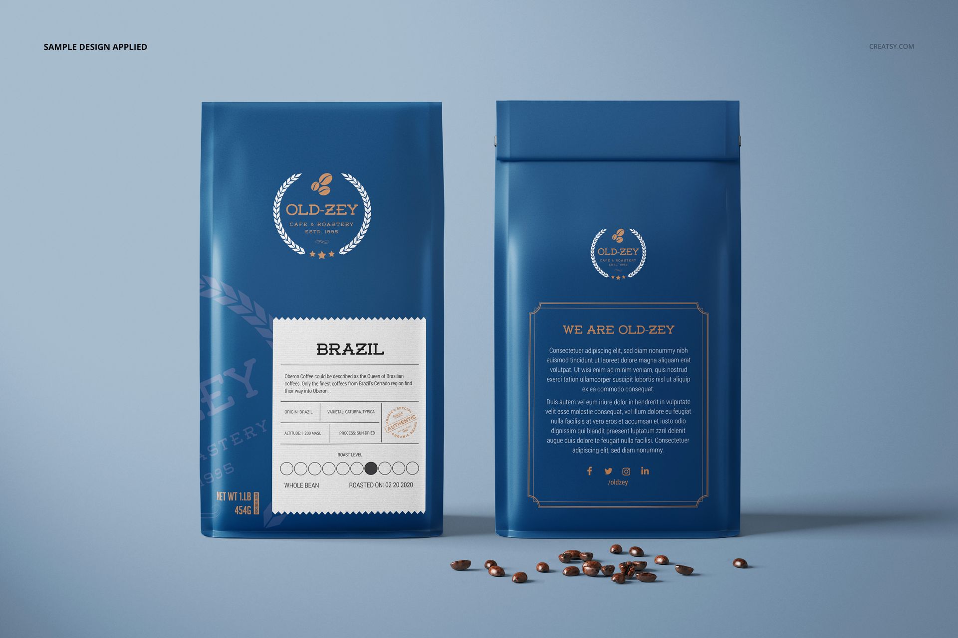 Blue paper coffee bag mockup set showing front and back sides, gold label details, and scattered coffee beans.