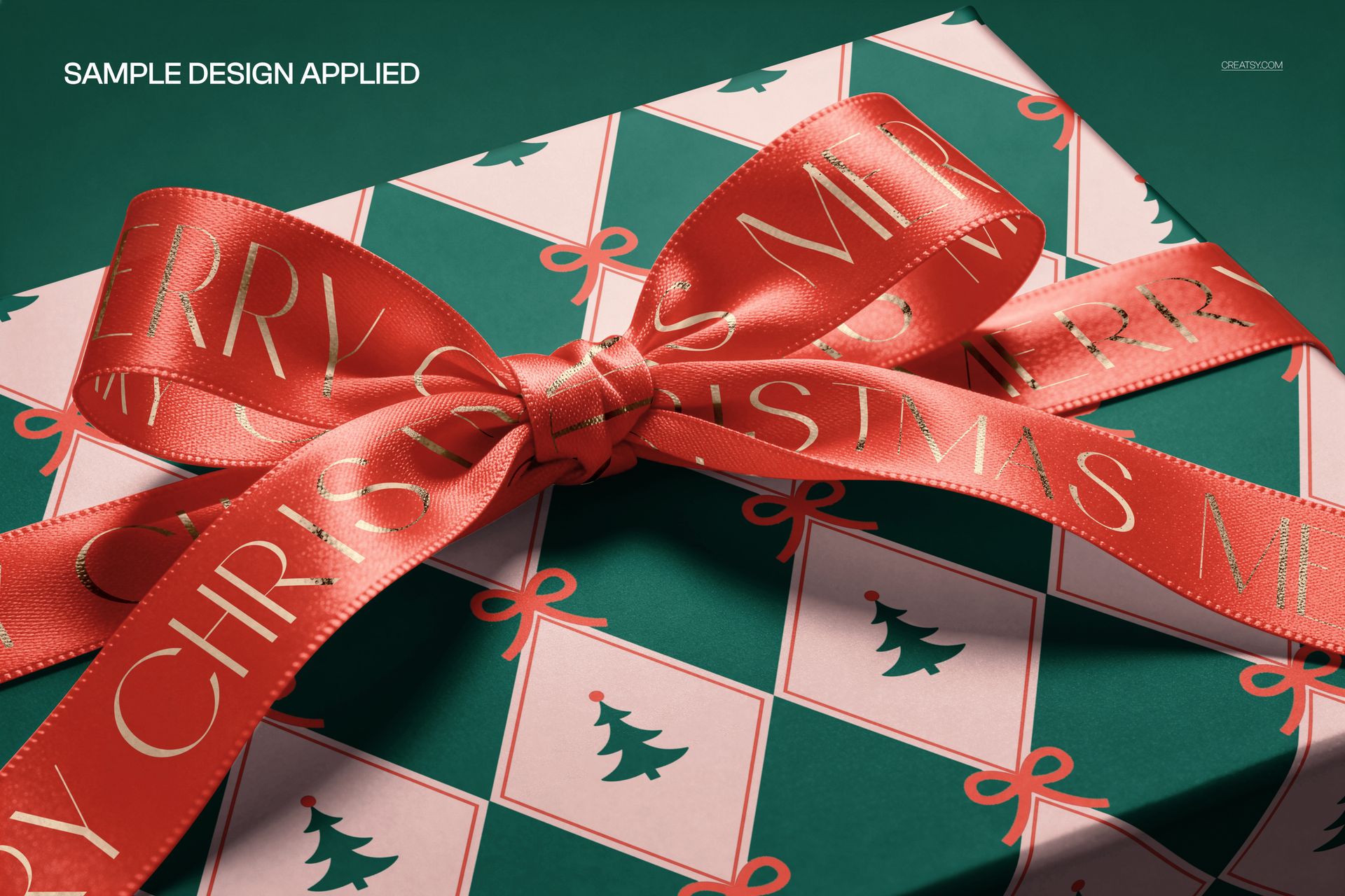 Gift box mockup decorated with a red satin ribbon and festive pattern, showing Christmas trees and bows, close-up angle.