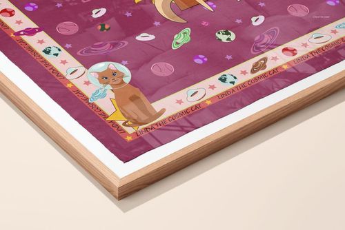 Corner view of a framed silk scarf featuring cartoon cats, planets, and stars on a magenta background, presented as a mockup.