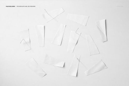 Assorted white fabric pieces arranged on a light background, viewed from above with visible sewing pins.