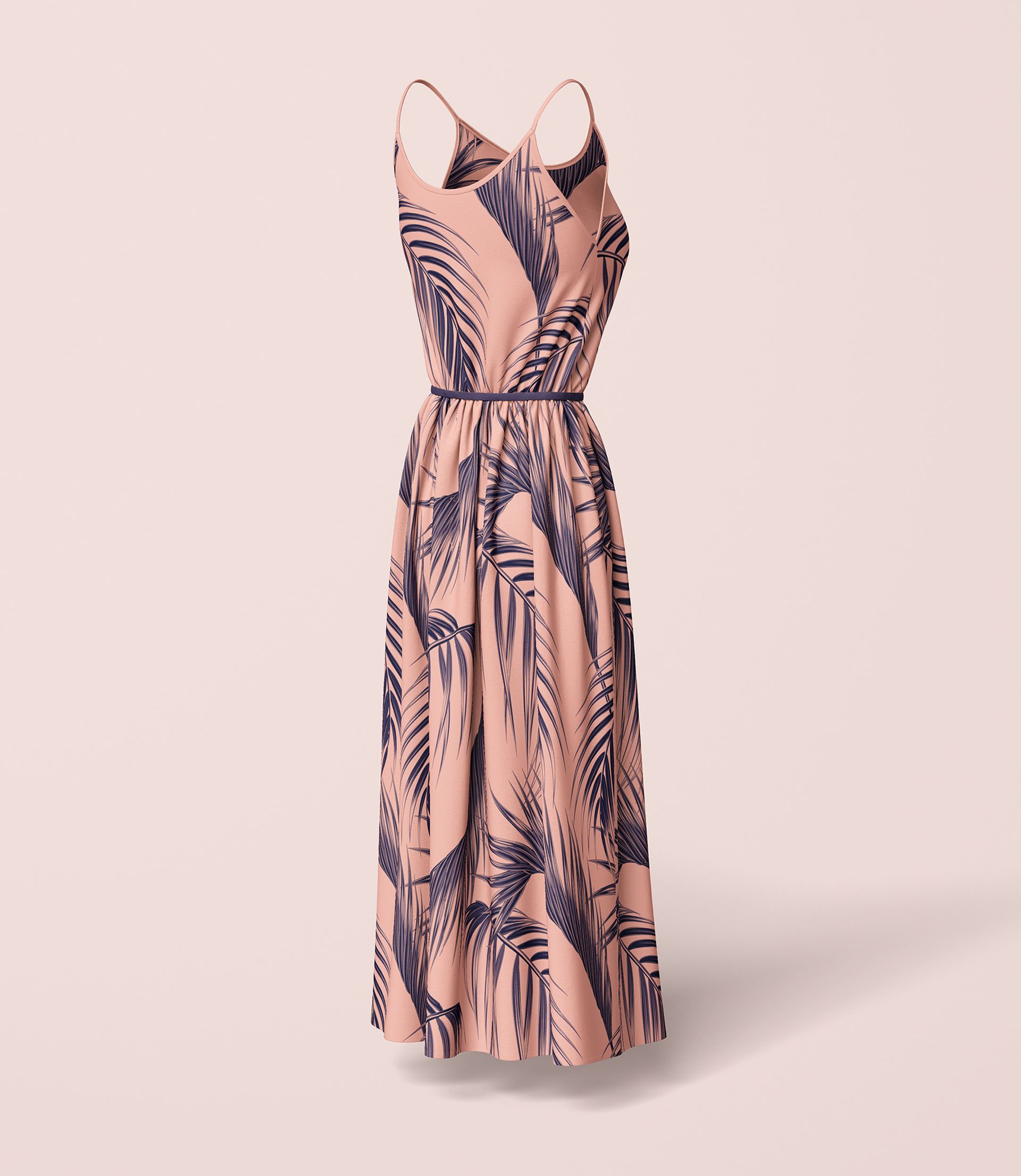 Long wavy dress mockup shown from the front, featuring a pink base with dark leaf patterns and thin shoulder straps.