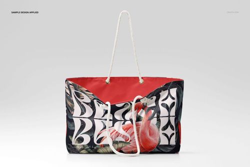 Weekender bag mockup with white rope handles, featuring a flamingo and leaf pattern on a red and black background.