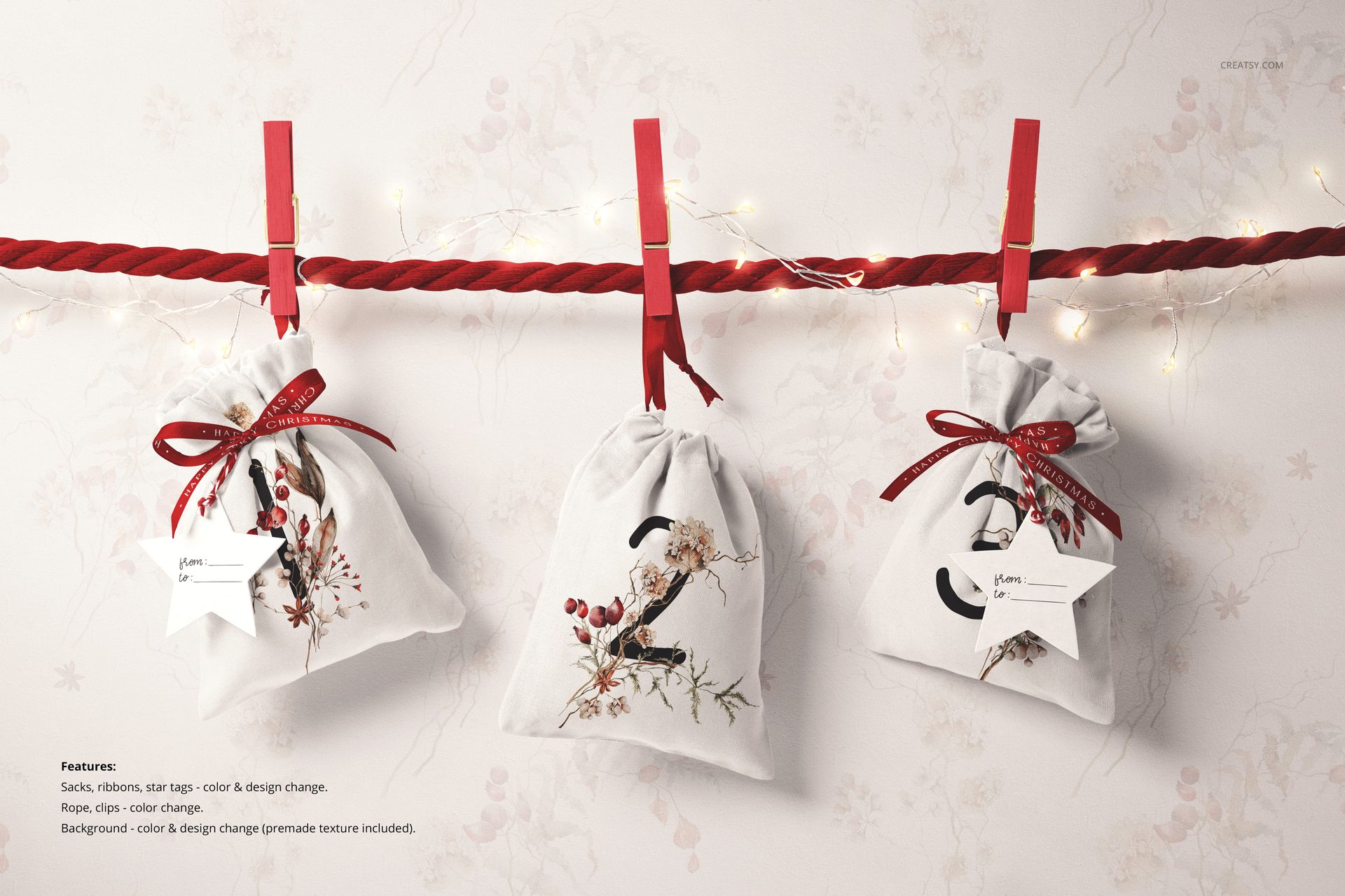 PSD mockup showing three decorative drawstring sacks with holiday prints, hanging on a rope with red clothespins.