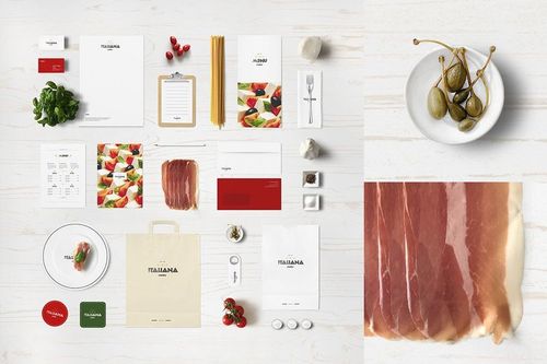 Italian restaurant stationery mockup featuring menus, envelopes, cards, and food props arranged on a white wooden surface.