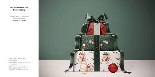 Stacked Christmas gift boxes with green striped and floral wrapping, topped with a large bow, front view mockup.