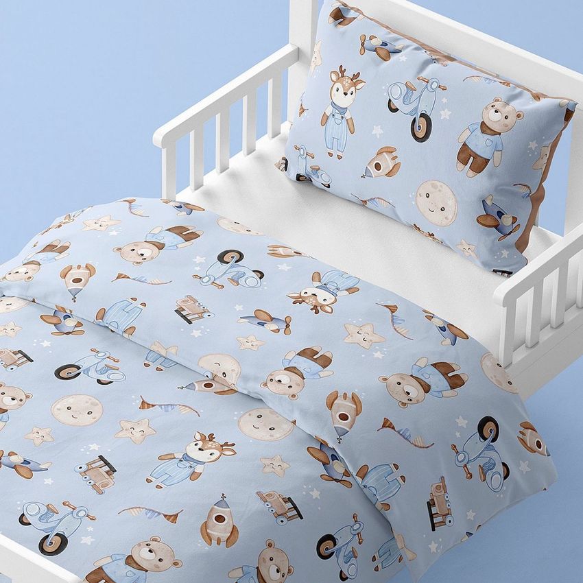 Toddler bedding mockup featuring a crib with light blue sheets and pillow covered in playful animal and toy illustrations.