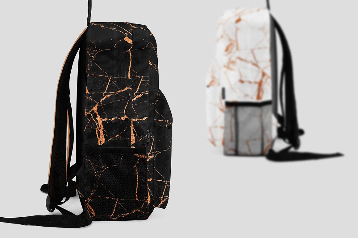 Two backpacks with marble patterns, one in black with copper lines and one in white with copper lines, side view on gray background.