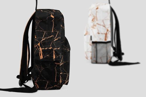 Two backpacks with marble patterns, one in black with copper lines and one in white with copper lines, side view on gray background.