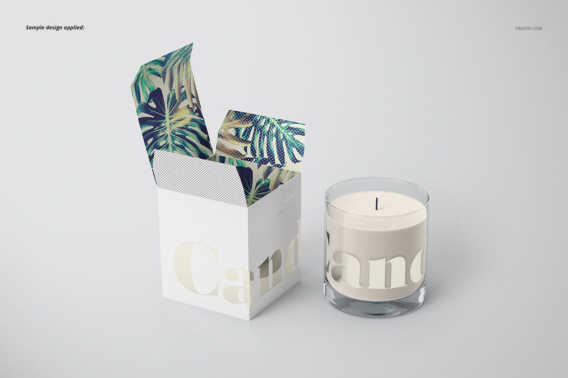 Classic candle mockup showing a round glass candle and a white box with botanical pattern inside, displayed on a plain surface.