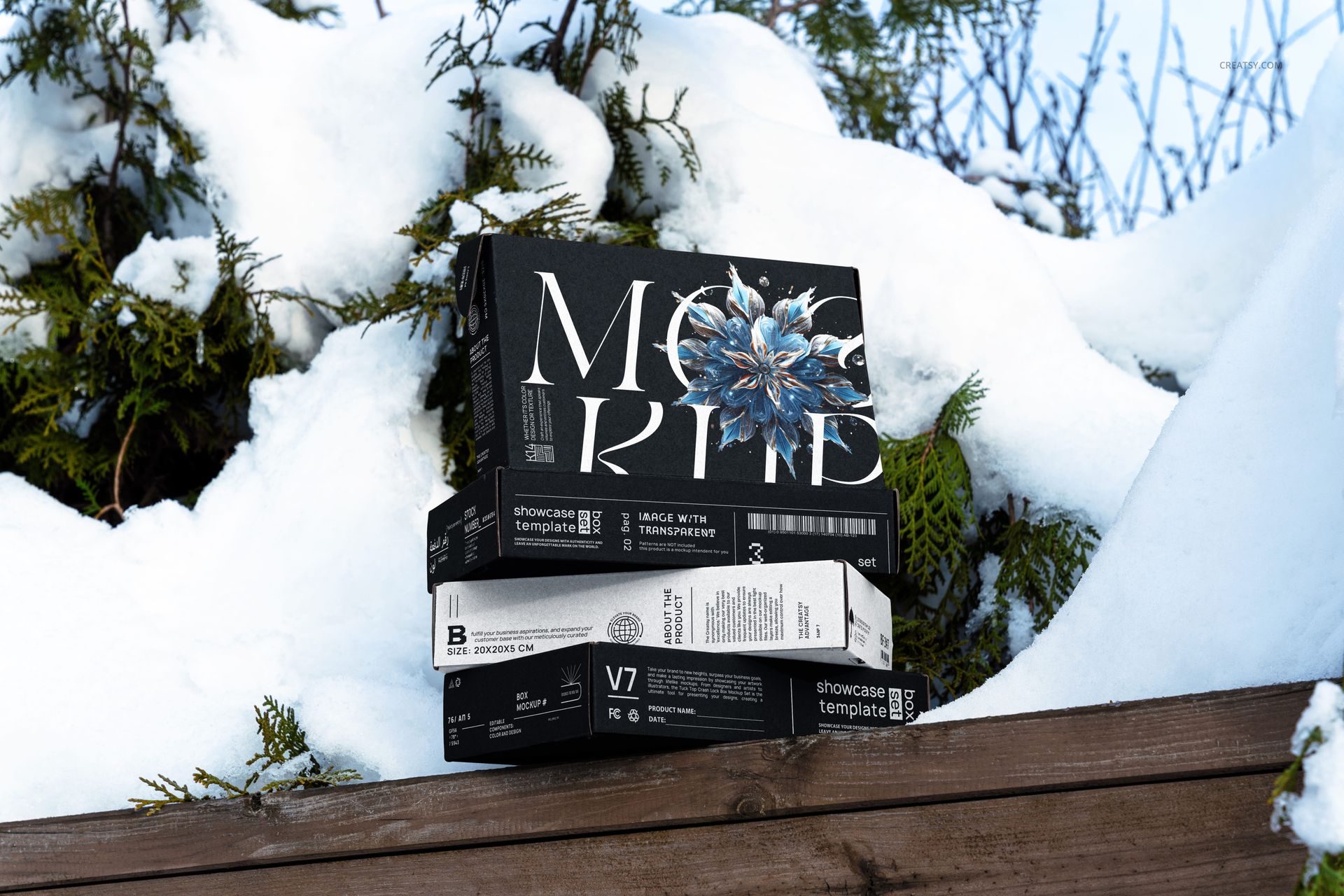 Winter edition mailing box mockup set featuring bold graphic designs, displayed on snow and green foliage outdoors.