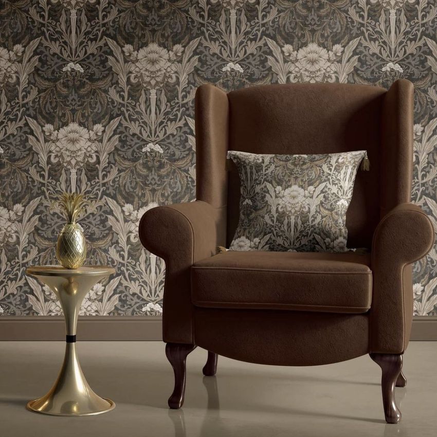 Retro velvet armchair mockup in a living room scene with brown upholstery, patterned cushion, and floral wallpaper background.