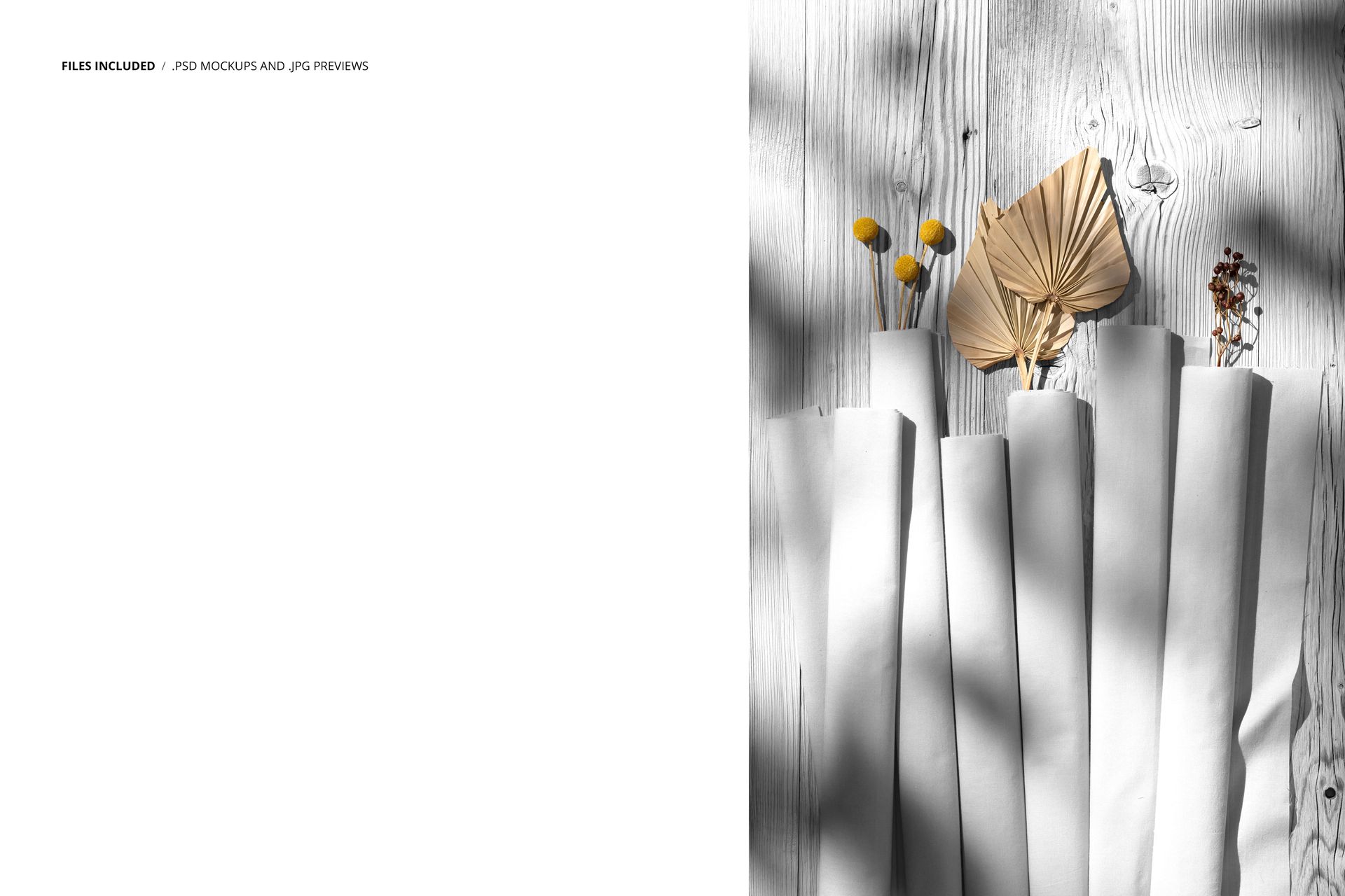 PSD mockup showing rolled cotton fabric samples and assorted dried botanical elements on a pale wood table.