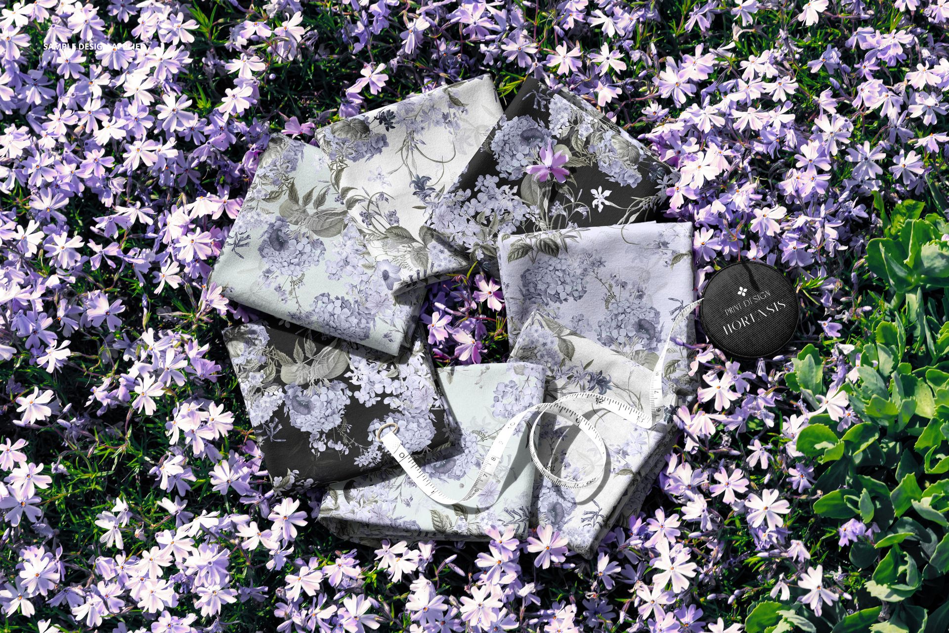 PSD mockup showing assorted fabric swatches with botanical designs placed on vibrant garden flowers.