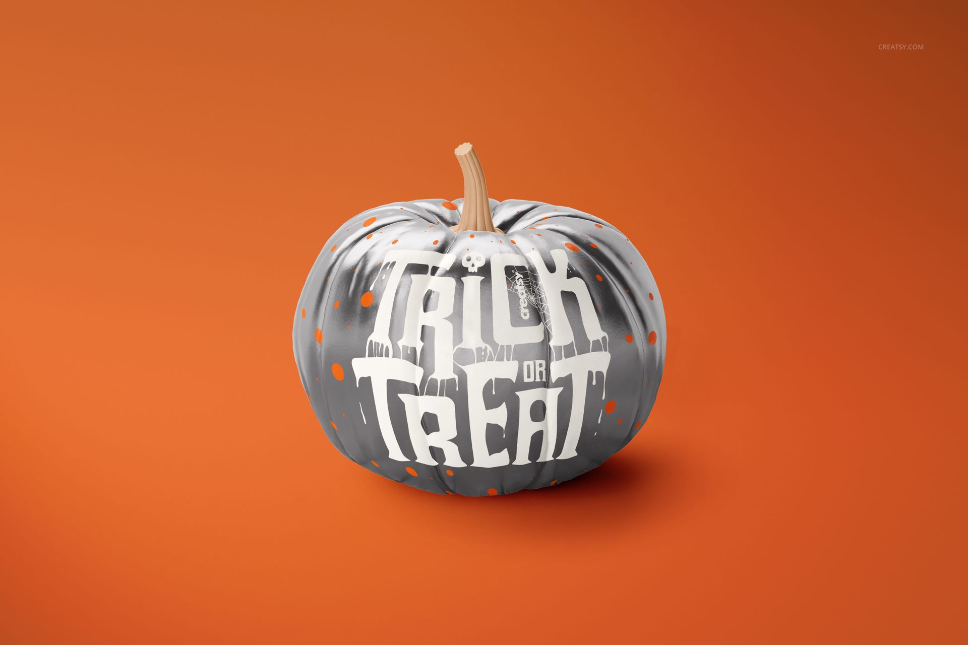 Front view of a pumpkin mockup with gray and orange paint splatters and 'Trick or Treat' text on an orange background.