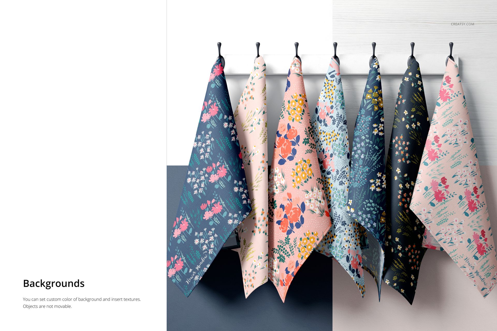 PSD mockup showing a row of six tea towels with colorful floral designs, hanging neatly on black hooks in a bright setting.
