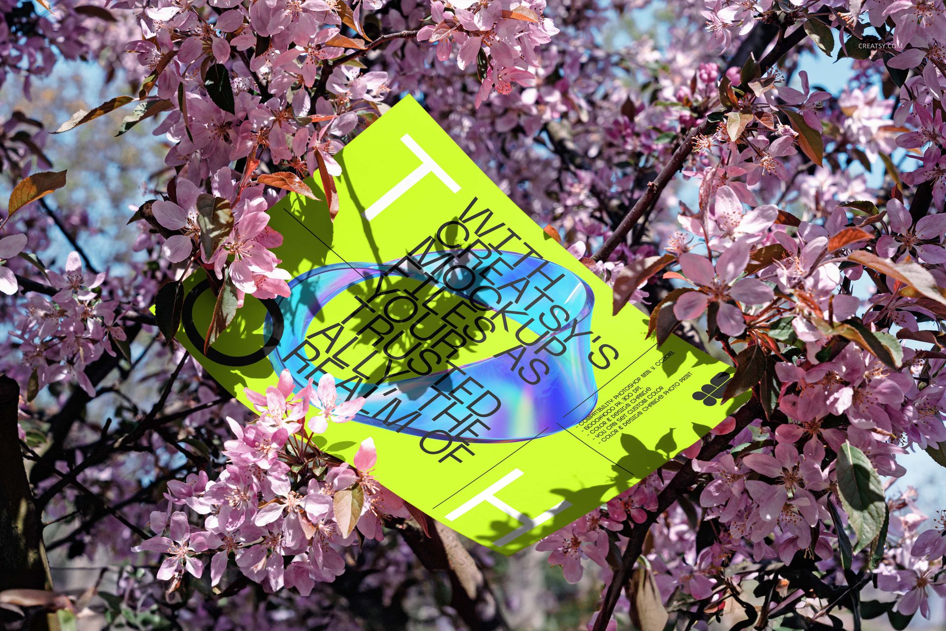 Bright green poster mockup displayed outdoors among blooming pink flowers, viewed from a slightly angled perspective.