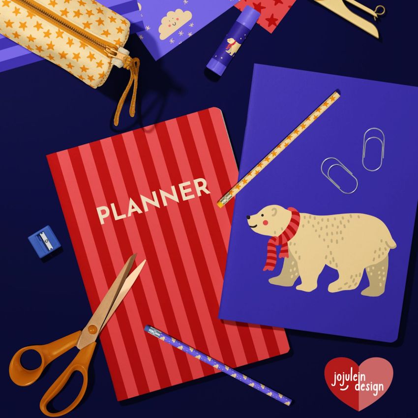 Stationery mockup featuring two A4 notebooks on a dark surface, one with red stripes and 'PLANNER' text, the other with a polar bear illustration.