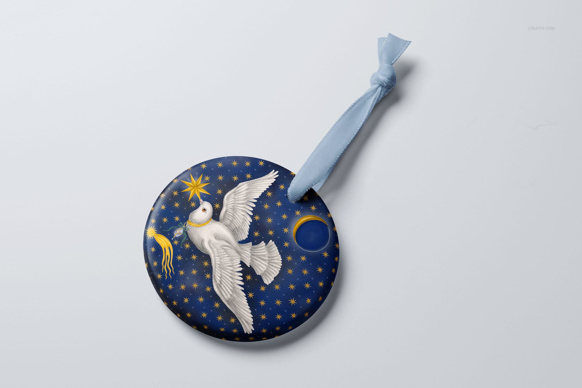 Round Christmas ornament mockup with a white dove and gold star pattern on a dark blue background, top view.