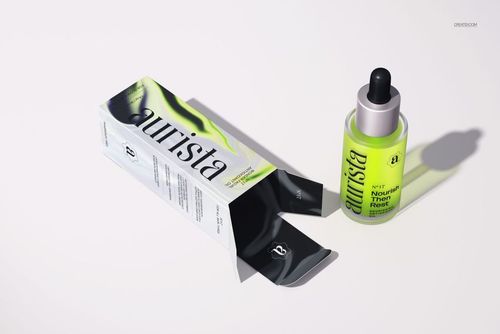 Dropper bottle mockup with green liquid and matching box, shown from an angled top perspective on a white background.