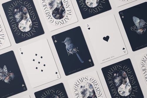 PSD mockup of playing cards laid out flat, displaying a mix of illustrated and minimalistic card faces in blue and white tones.