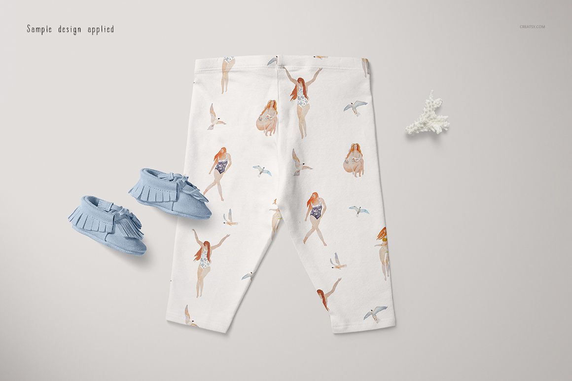 PSD mockup featuring baby leggings with illustrated swimmers and birds, paired with blue moccasins and a coral accent.