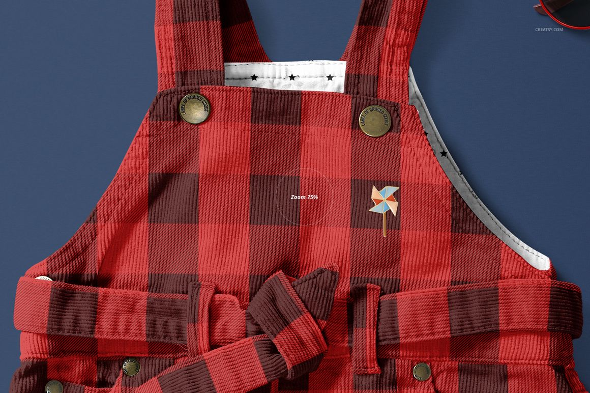 Front view of a baby dress mockup with red and black plaid pattern, corduroy texture, and decorative buttons.