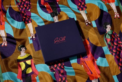 PSD mockup of a fashion accessory set displaying a patterned silk scarf and a matching dark blue presentation box.