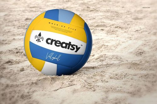 Front-facing volleyball ball mockup with multicolor design and text, positioned on a textured sand surface.