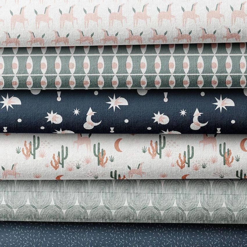Fabric stack mockup featuring five folded textiles with various patterns, including cacti, stars, and abstract shapes in muted tones.