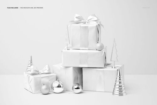 PSD mockup featuring a group of large Christmas gifts in white wrapping, accented by metallic ornaments and festive props.