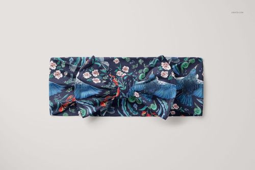 PSD mockup of a kids bow tie headband featuring a vibrant blue and green bird and floral design, displayed flat from above.